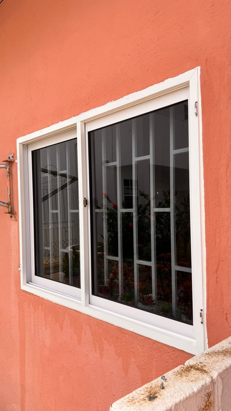 Hinged insect screen on a window in Curaçao