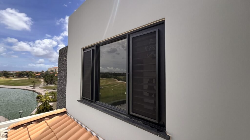 Modern fixed insect screen on window in Curacao